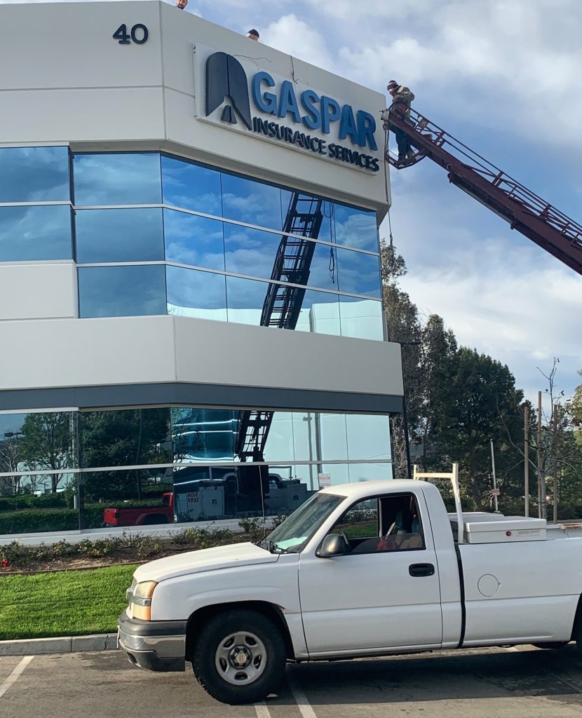 Exterior photos of reverse lit channel letters being installed by crane on the Gaspar Insurance office building in Simi Valley. This exterior building sign is part of the office sign package provided by Premium Sign Solutions. Sign Makers in Simi Valley.