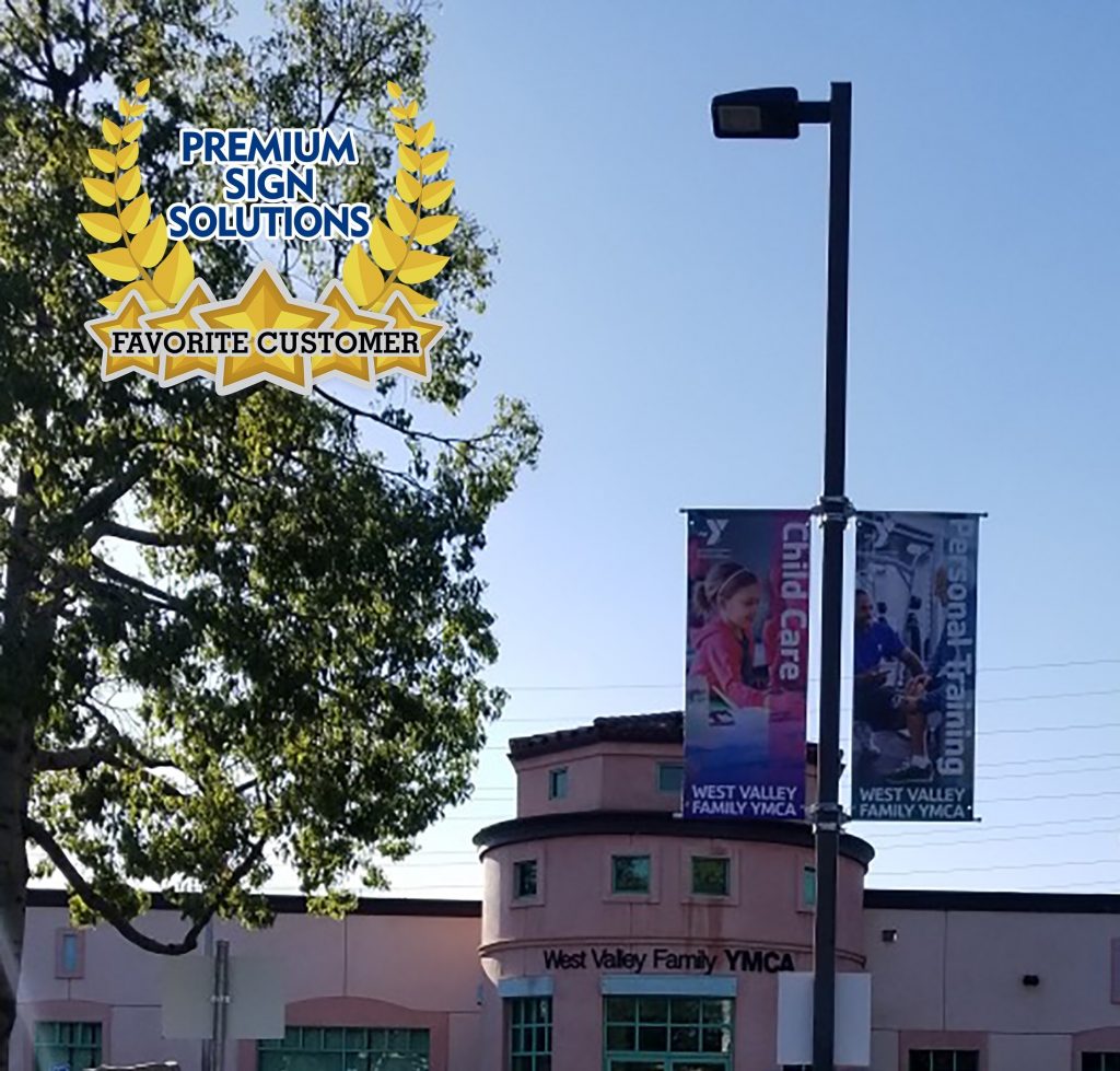 Premium Sign Solutions' Honoring Our Favorite Customers seal over a an outdoor photoraph featuring pole banners made for West Valley YMCA.