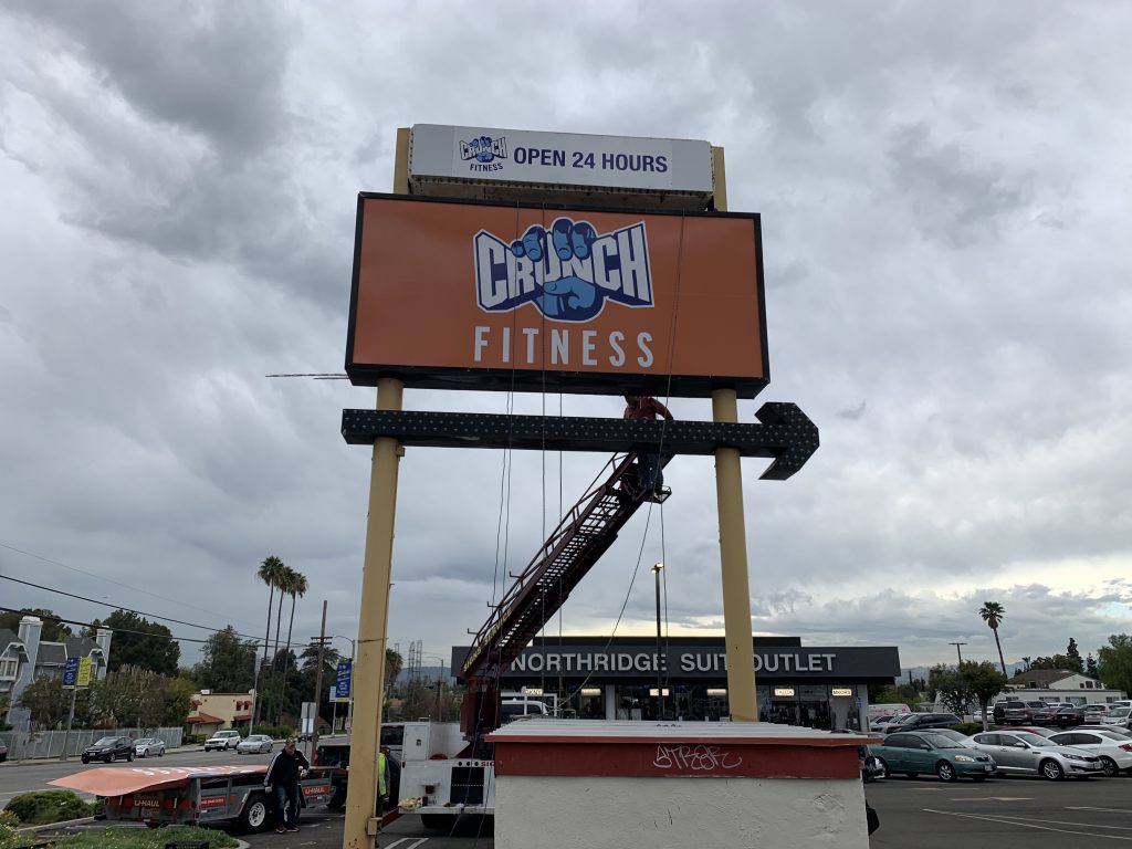 More signage for Crunch Fitness. This time it is their branch in Northridge, which is getting a new gym pylon sign insert installed.