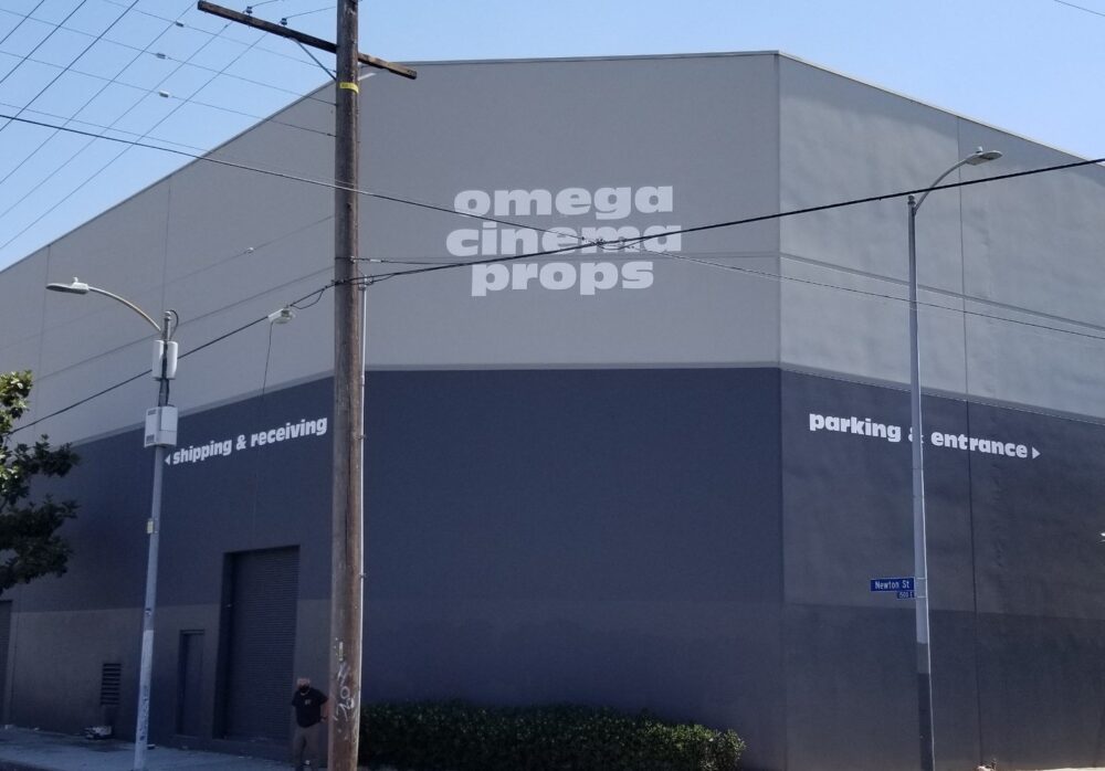 Hand-Painted Business Sign for Omega Cinema Props in Los Angeles