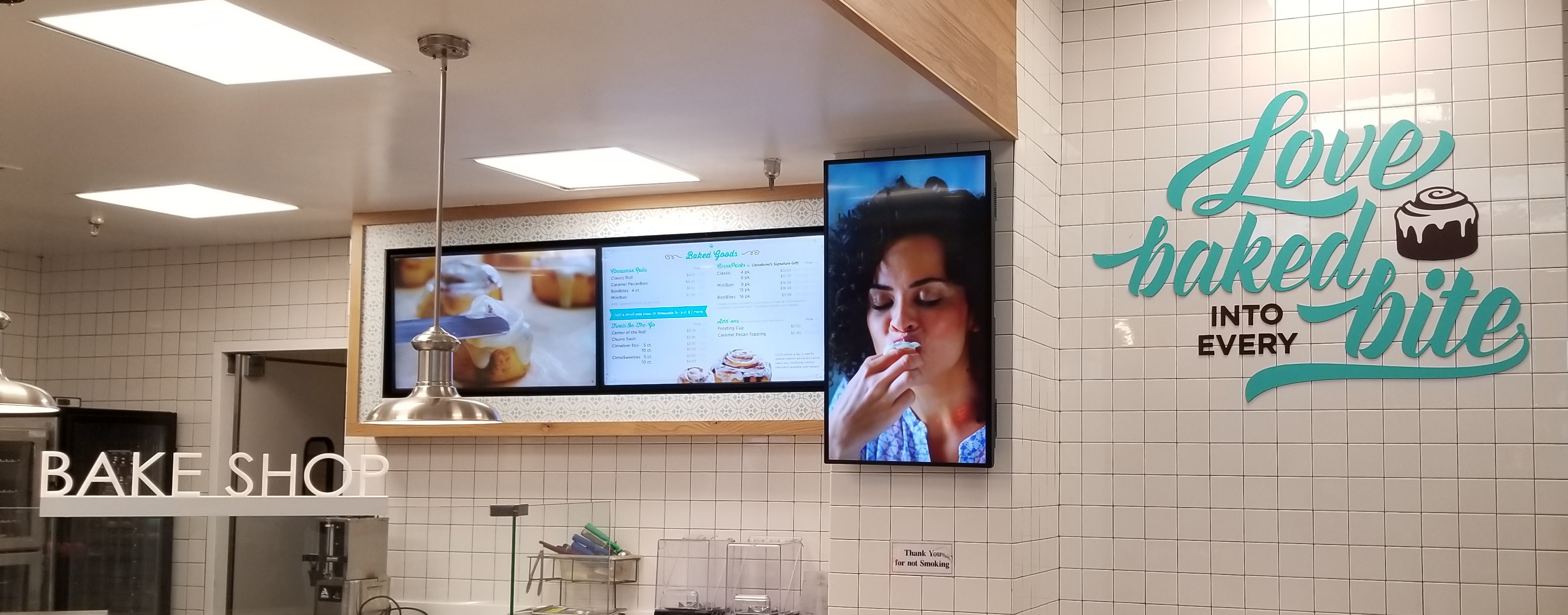 Cinnabon's new restaurant lobby sign that very cutely tells people that "Love is Baked Into Every Bite," made in partnership with TubeArt. 