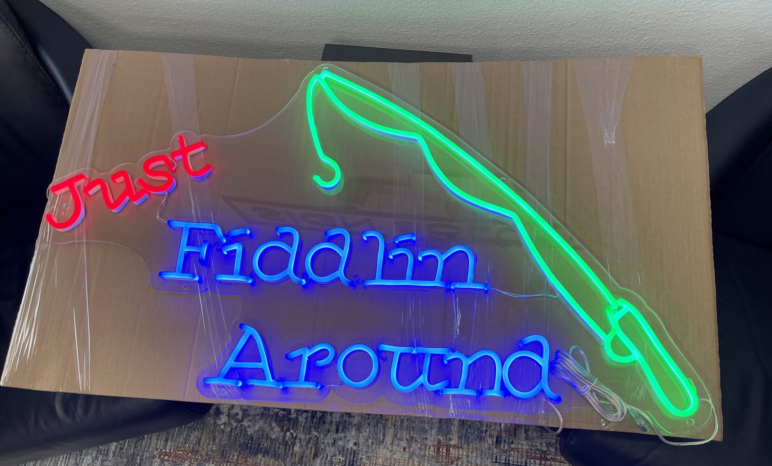 The holidays are approaching and it's time to decorate places with signage even give them as gifts. Like this neon sign gift spelling out "Just Fiddlin Around."