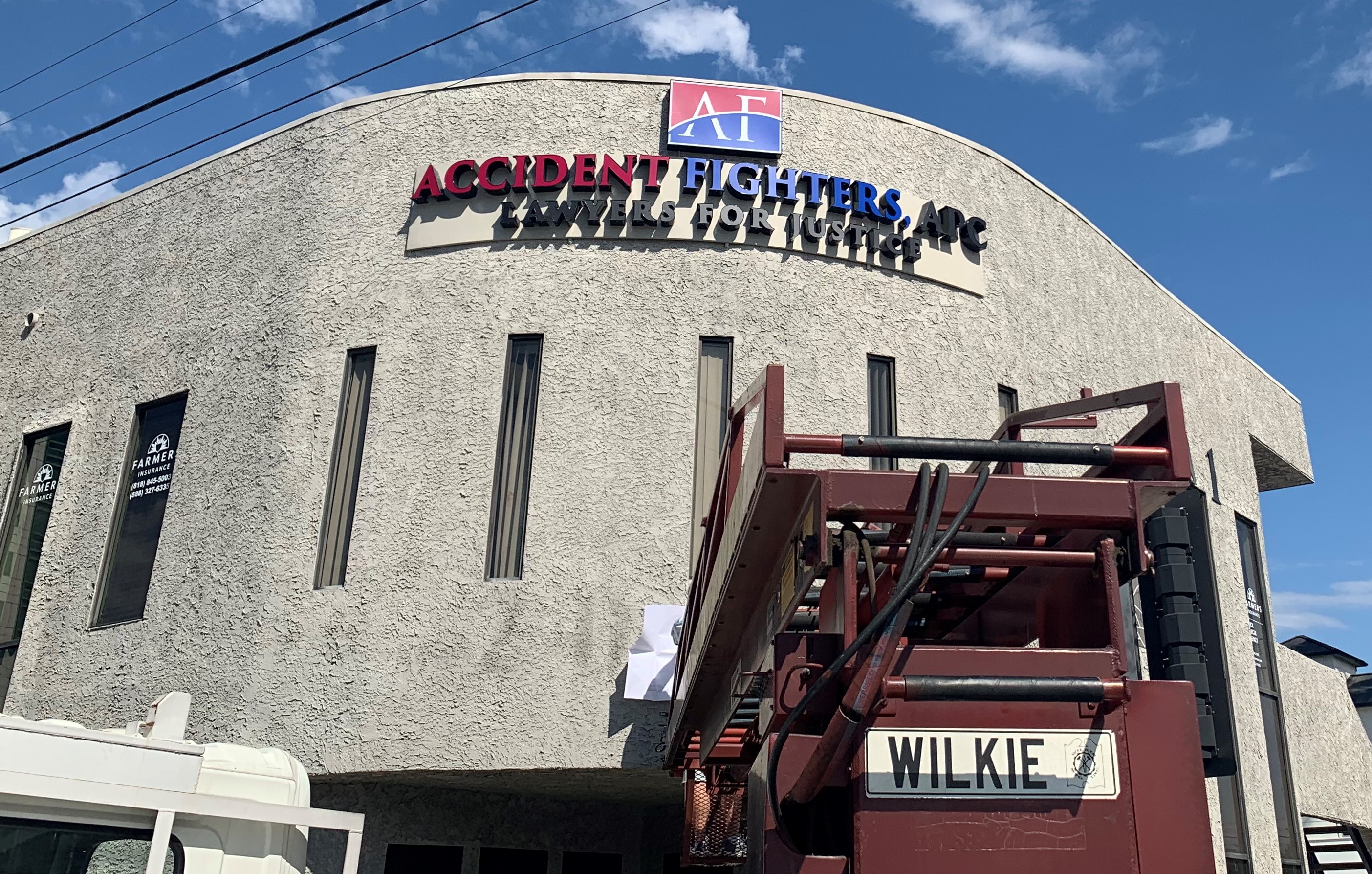 A captivating building sign is a must have to stand out. Like this sign combination of a light box and channel letters for Accident Fighters' Burbank office.