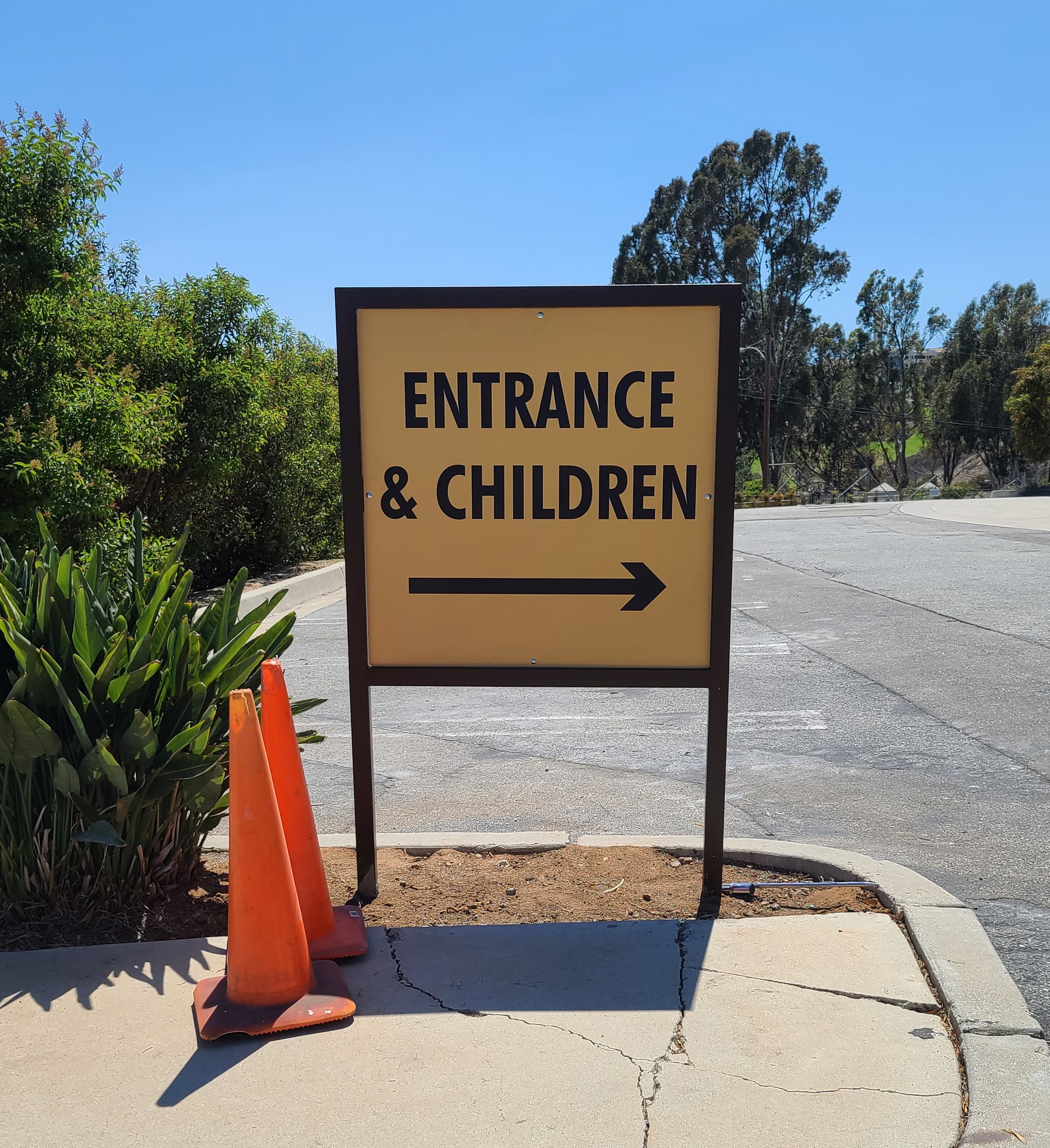 This post and panel directional sign for Malibu Presbyterian Church directs visitors to the entrance area and the church's children section.