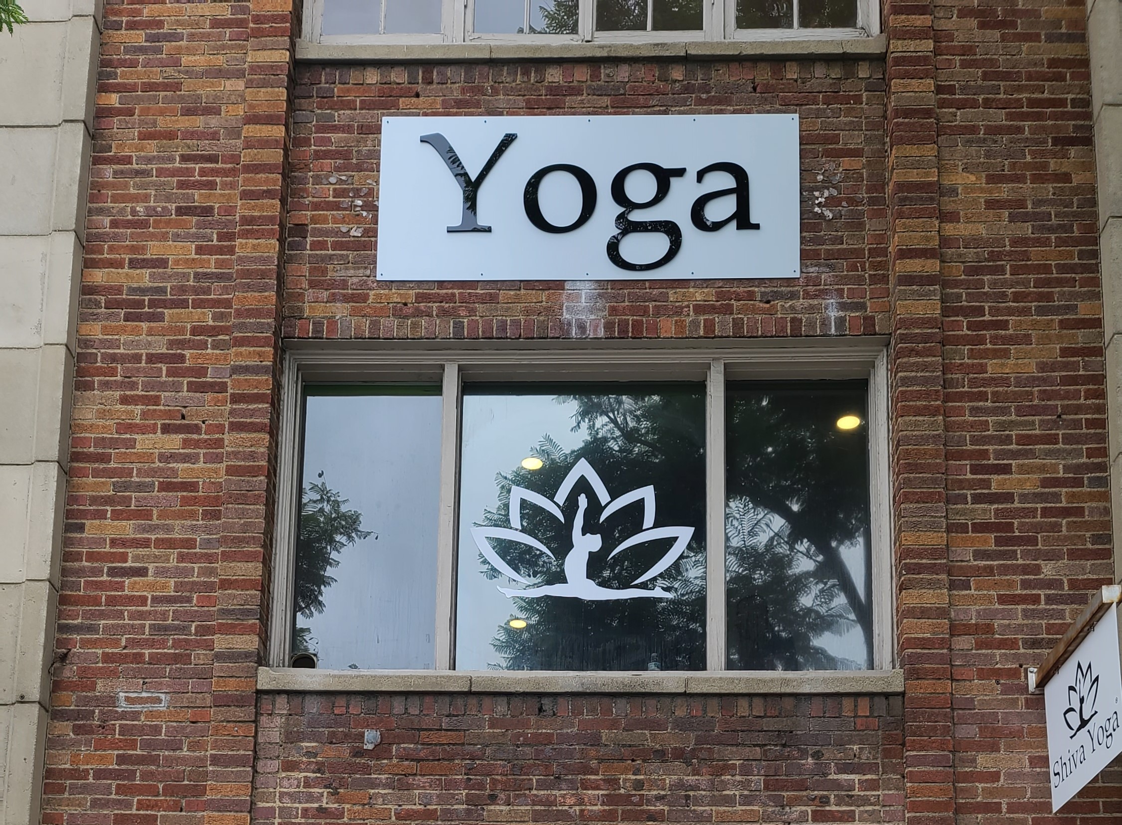 This is the studio sign for Shiva Yoga's West Hollywood establishment, composed of acrylic letters on a metal panel over their entrance.