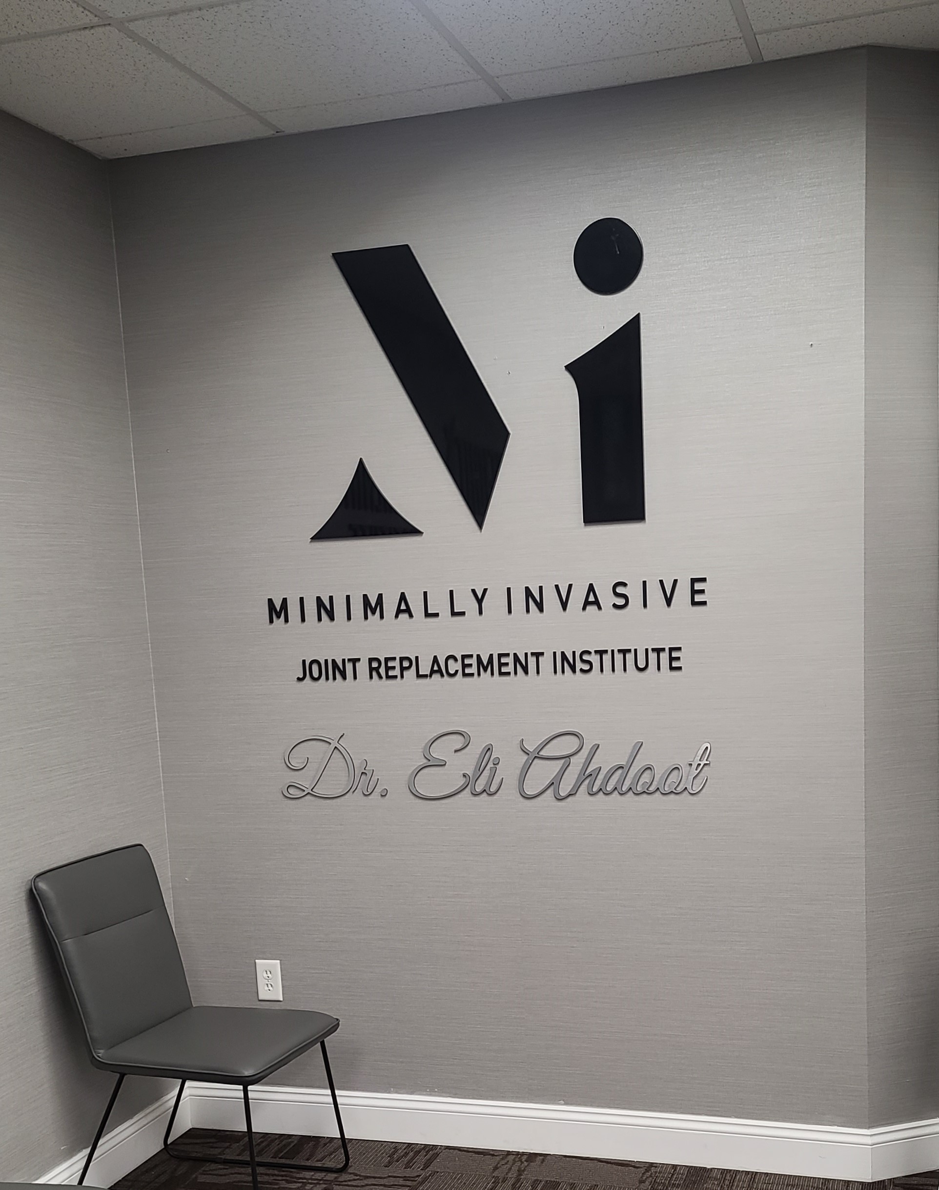 This clinic lobby sign we fabricated and installed for Minimally Invasive Joint Replacement Institute's Burbank practice enhances the office.