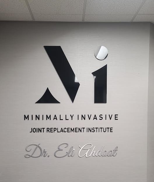 This clinic lobby sign we fabricated and installed for Minimally Invasive Joint Replacement Institute's Burbank practice enhances the office.