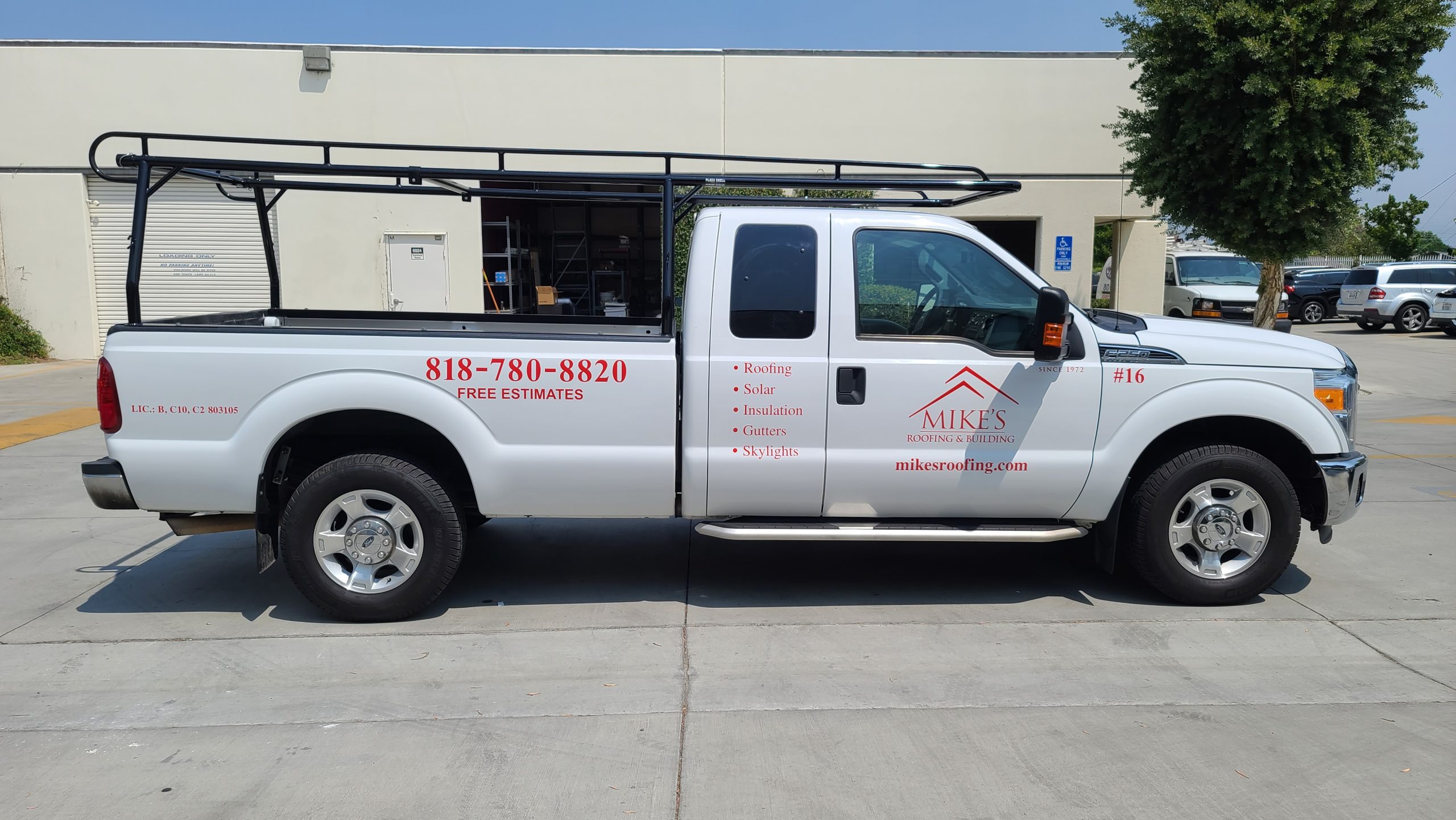 Rebranding also applies to vehicle wraps and graphics, like these new car decals for Mike Roofing's service truck featuring their logo and contact details.