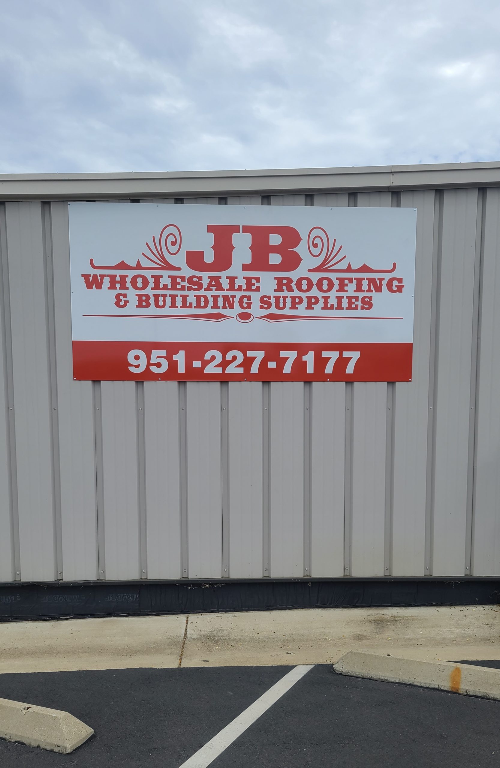 This metal panel sign for JB Wholesale Roofing's parking lot in Murietta features their logo and contact details, giving their brand more visibility.