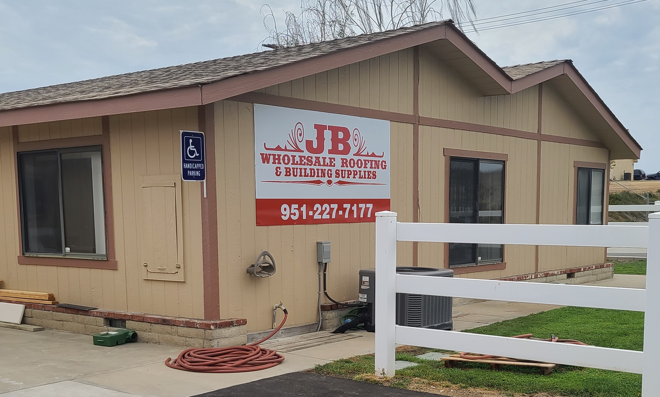 More from our sign package for JB Wholesale Roofing's Murrieta location, a metal panel building sign that displays their brand logo and its contact details.