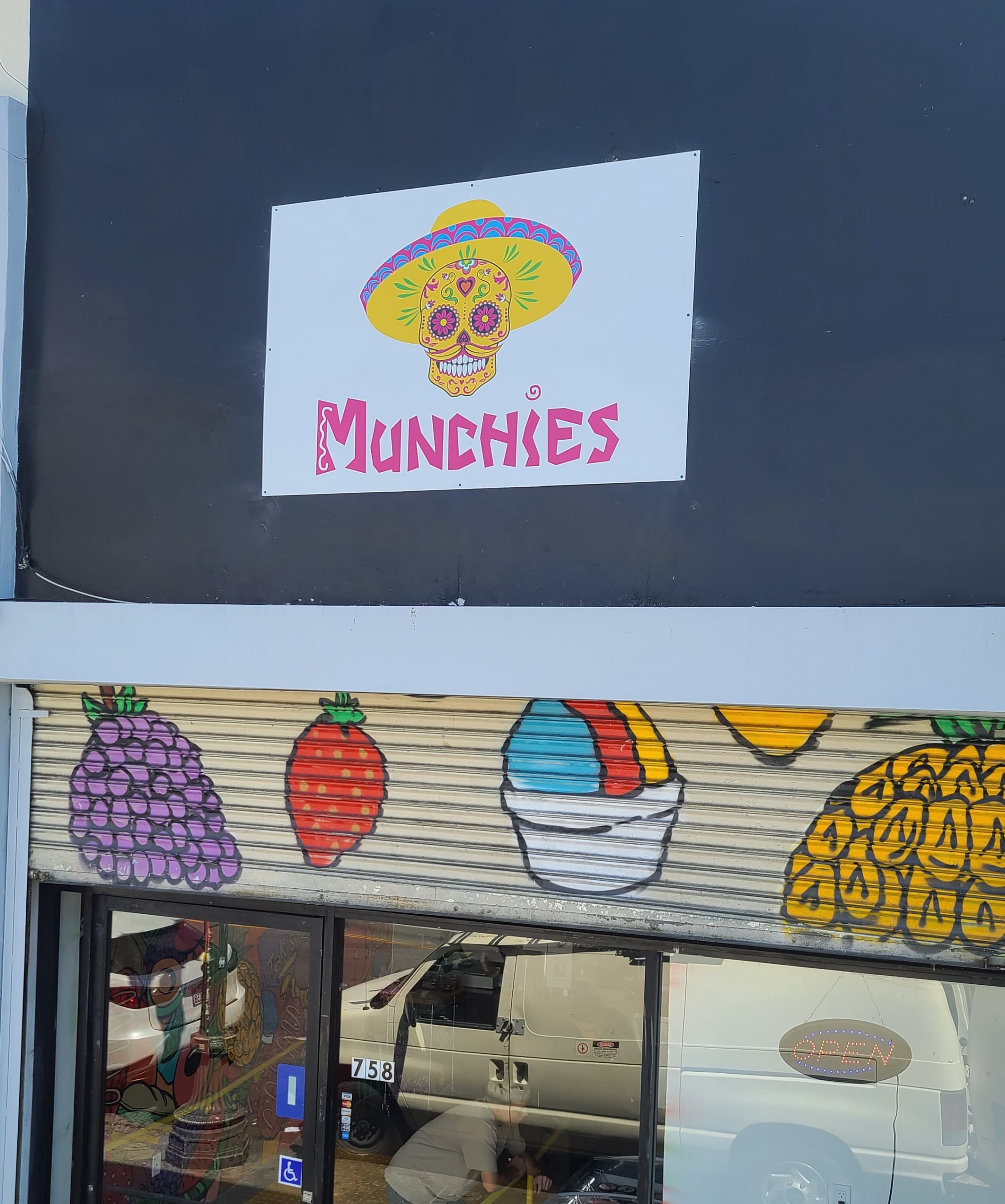 This is the storefront sign we made for Munchies, the restaurant sign has an eyecatching Día de los Muertos skull printed design.
