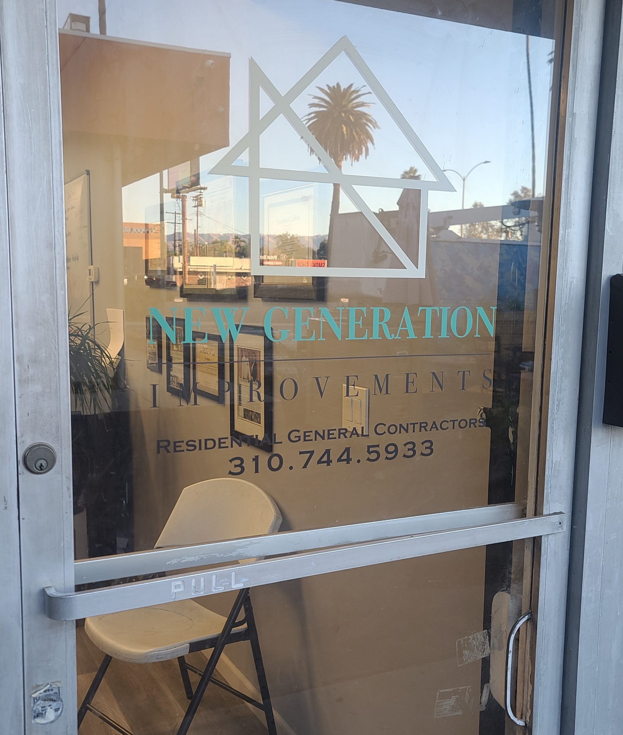 The storefront signs for New Generation Improvements for their Reseda office include glass door graphics that show their company logo and their contact details.