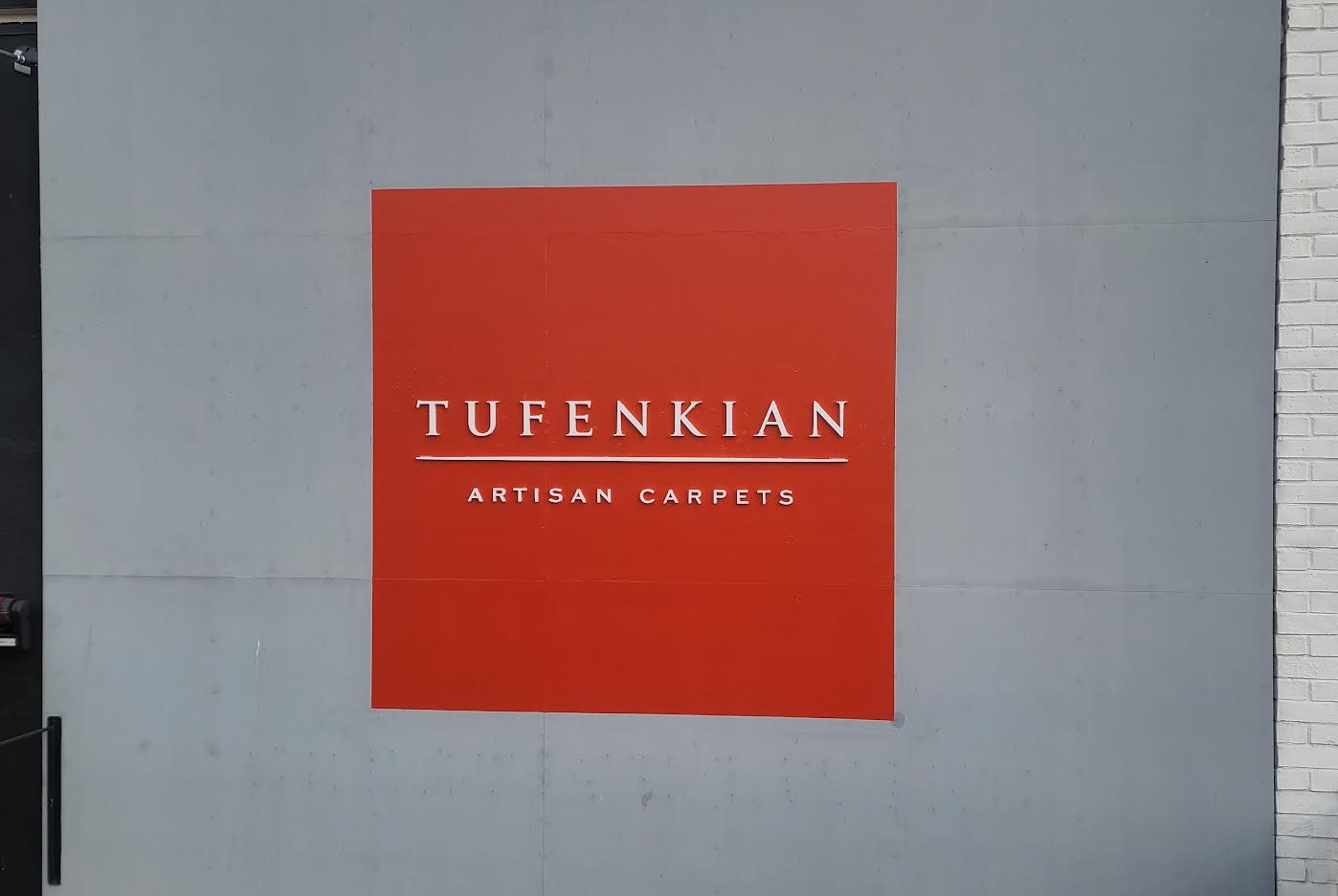 For Tufenkian Artisan Carpets we painted their exterior wall white, painted a red square and then installed laser cut white acrylic letters.