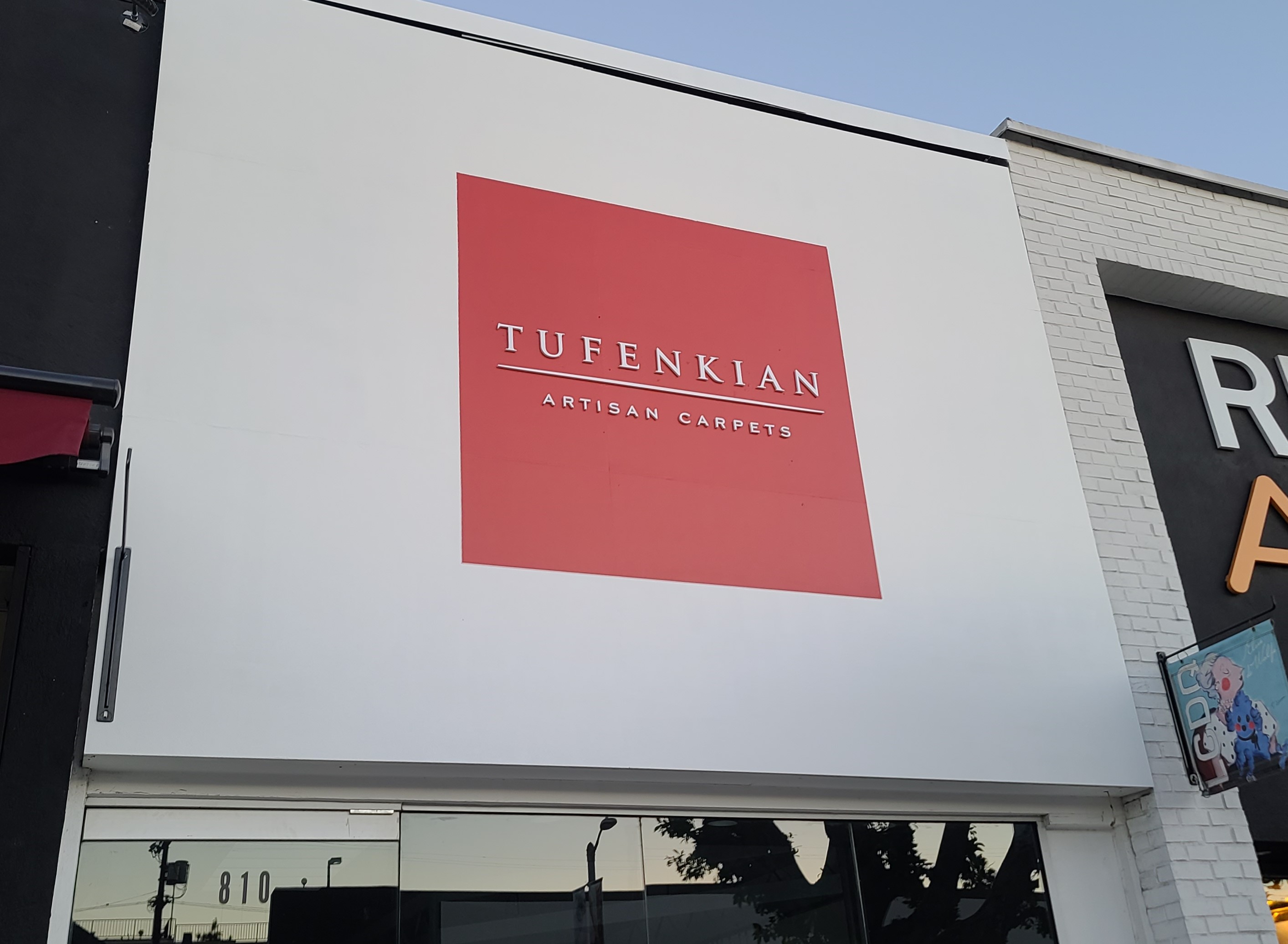 For Tufenkian Artisan Carpets we painted their exterior wall white, painted a red square and then installed laser cut white acrylic letters.