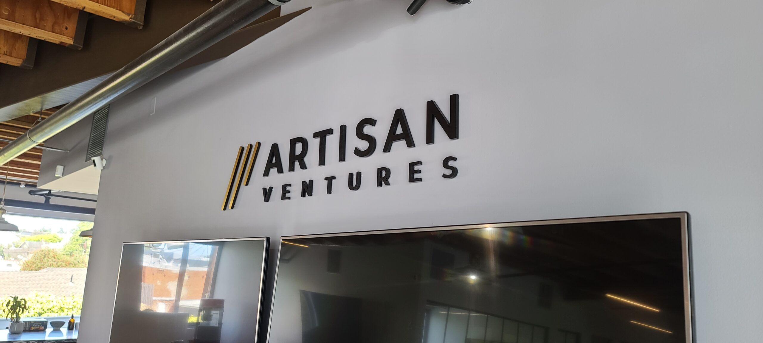 This acrylic wall sign for Artisan Ventures' office in Santa Monica decorates the space, giving it style and boosting their brand's visibility. 