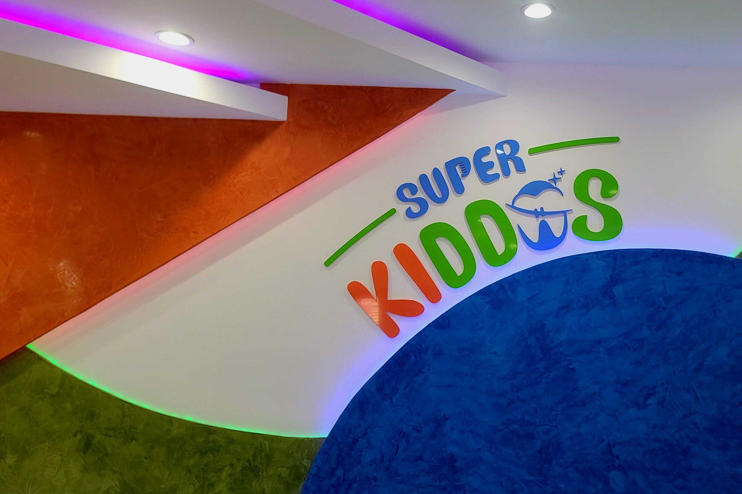 Indoor kids play area bright wall shapes, which complement the signage on a light background