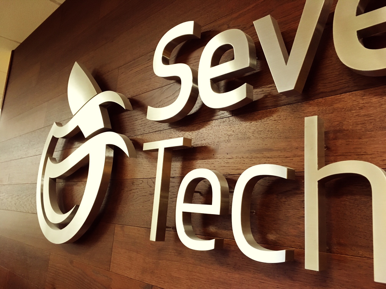 Brushed Metallic finished lobby sign on wooden backing