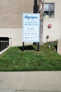 Stylish real estate post and panel signage against the West Hollywood backdrop