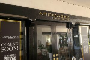 Shop Signage - Aroma 360's outdoor sign beautifully blends with their shop's aesthetic.