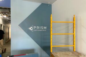 Lobby sign with 'PRISM' in white acrylic - Premium Sign Solutions