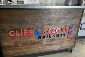 Sleek Reception Sign at Clips and Razor