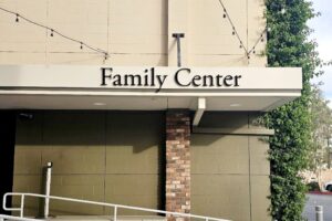 Family Center's vibrant acrylic sign above the ramp exudes warmth, inviting all to gather.