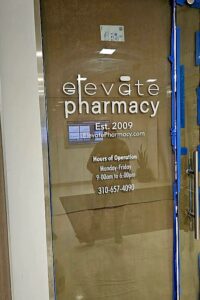 Vibrant window decal showcasing Elevate Pharmacy's logo.