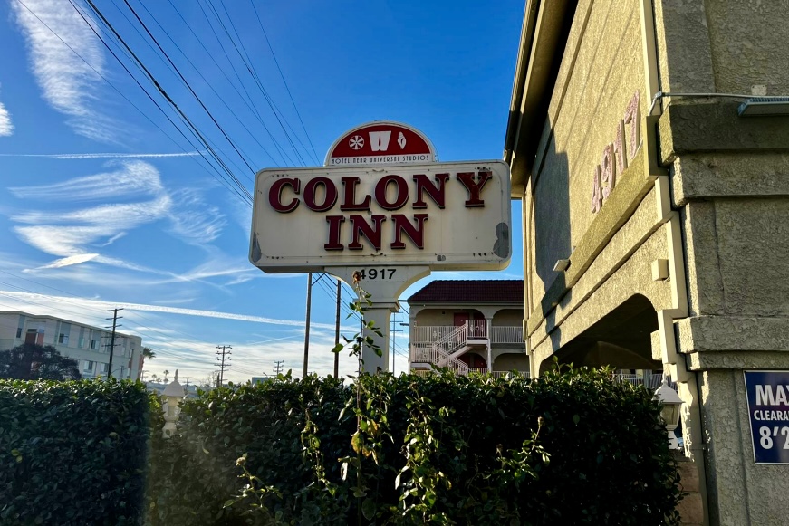 Worn-out pole sign with faded logo and lettering at the Colony Inn in North Hollywood needing sign retrofits