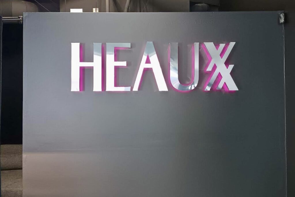 Heaux's indoor channel letter lobby sign viewed from afar, highlighting its visibility and elegance.