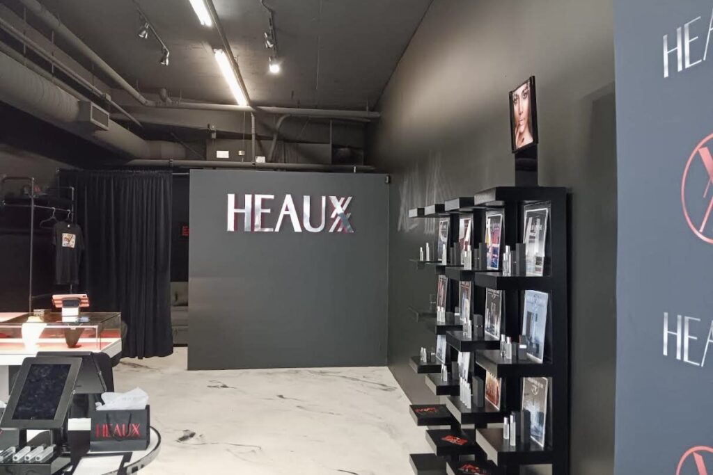 Close-up of illuminated indoor channel letter lobby sign for Heaux.