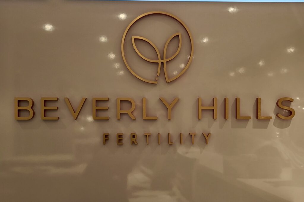 Lobby sign for Beverly Hills Fertility in brushed gold acrylic by Los Angeles sign maker Premium Sign Solutions.