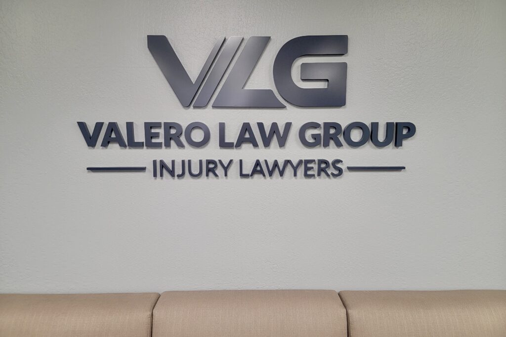 Lobby sign for Velero Law Group in brushed metallic black acrylic by Los Angeles sign maker Premium Sign Solutions.