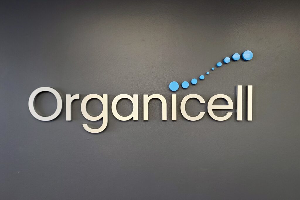 Lobby sign for Organicell in brushed gold acrylic by Los Angeles sign maker Premium Sign Solutions.