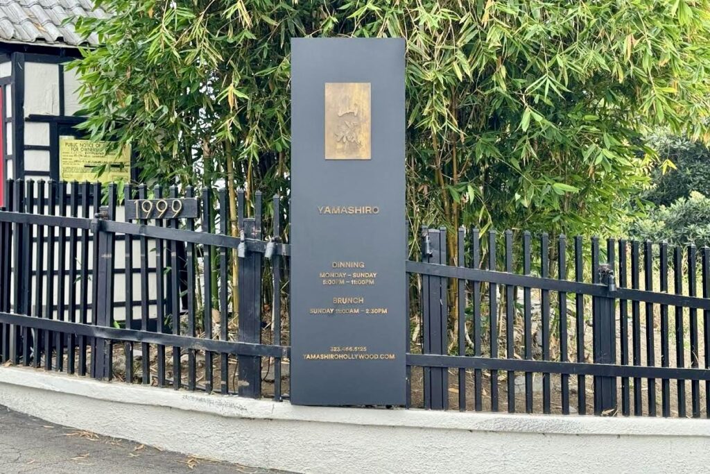 Front view of Yamashiro Hollywood’s monument sign featuring detailed craftsmanship and elegant lighting.