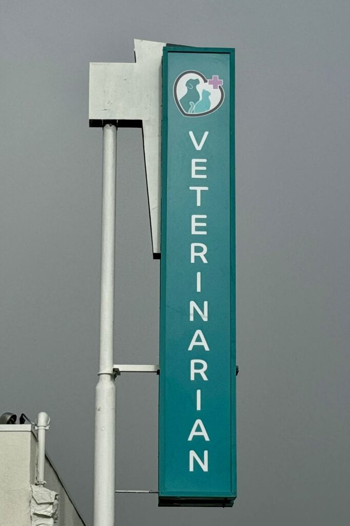 Pet Medical Center Sunland blade sign attached to pole, highlighting the clinic from the street.