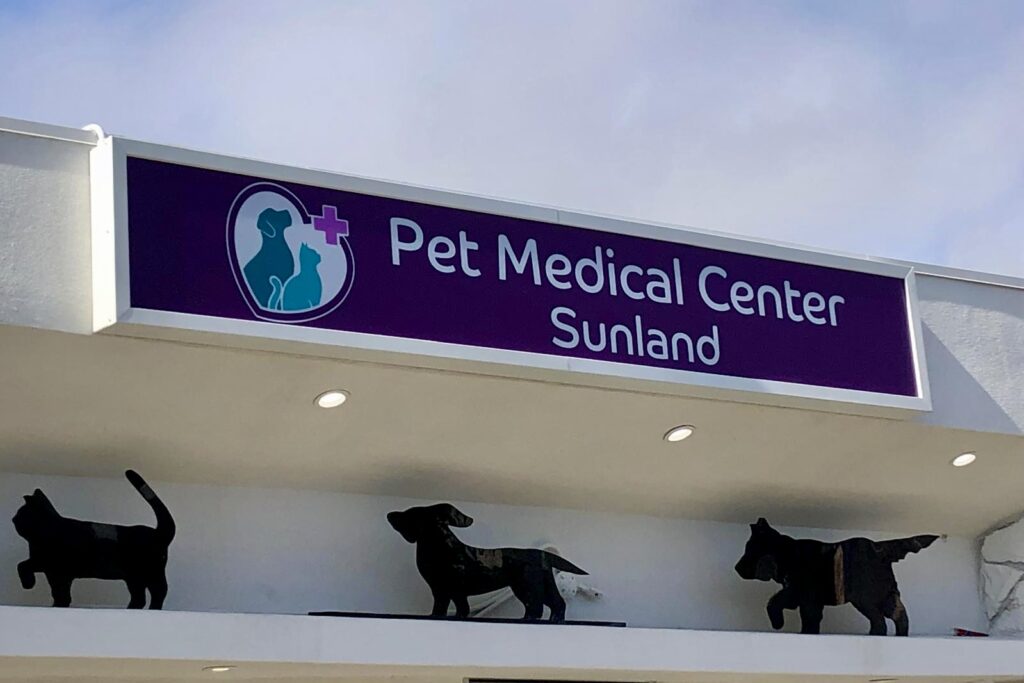 Pet Medical Center Sunland lightbox sign above entrance, featuring animal silhouettes.