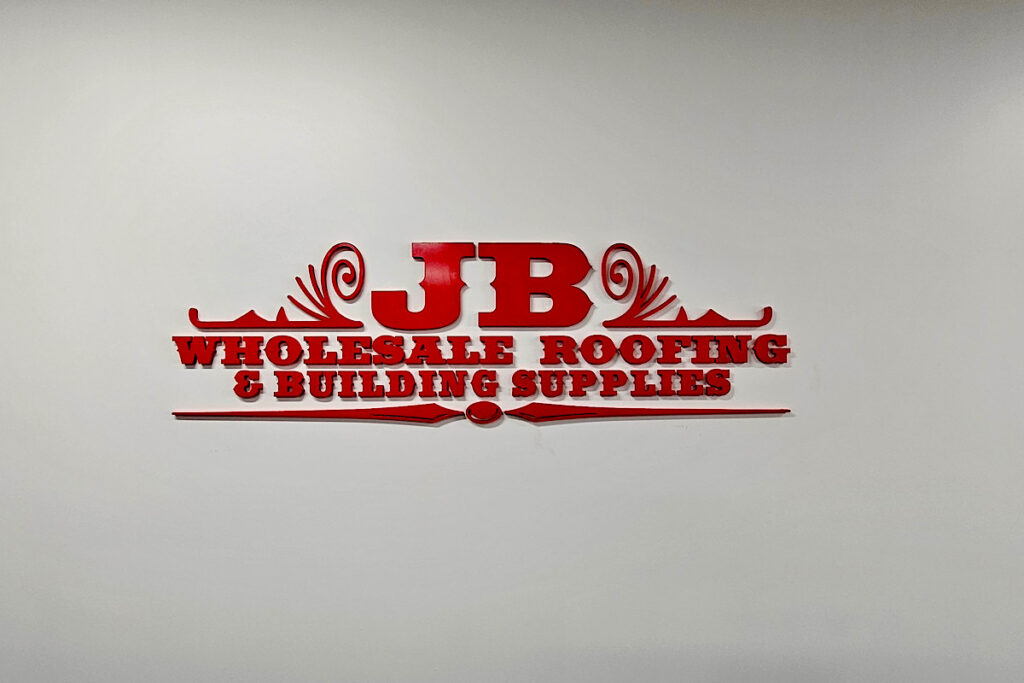 A view of the JB Wholesale wall with the relocated signage installed. The sign is visible, creating a strong brand presence for the company.