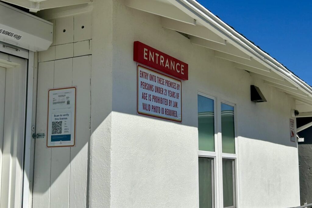 Exterior view of Megan Organic Market storefront with a custom-designed entrance sign. The signage is crafted from high-quality materials and reflects the brand's commitment to organic and healthy living.
