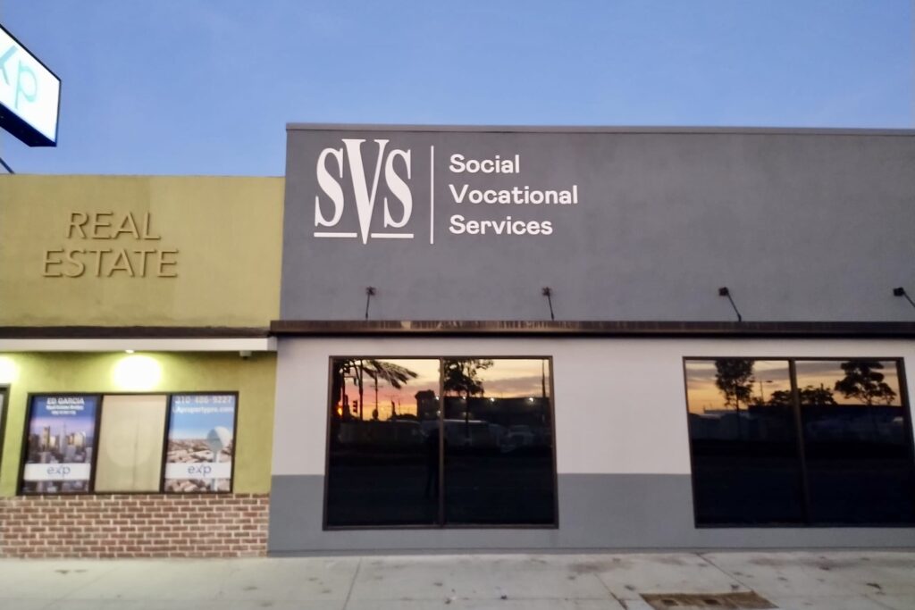 Wide shot of a fabricated stainless steel sign spelling out “Social Vocational Services” in raised dimensional letters. (Hawthorne location)
