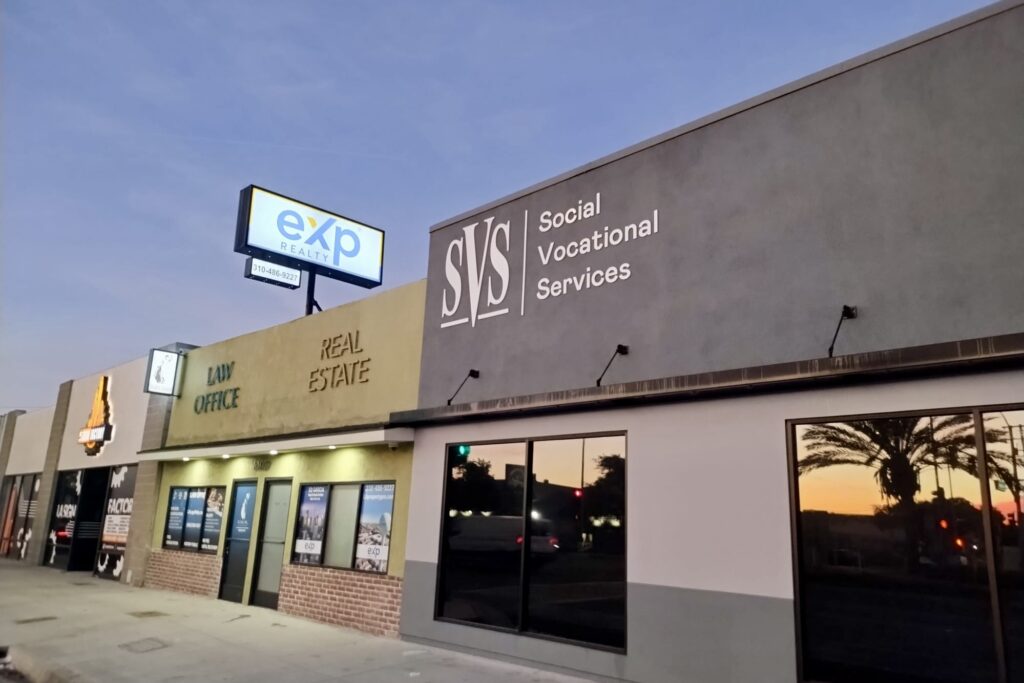 A broad view of a fabricated stainless steel sign that reads "Social Vocational Services" in raised, three-dimensional letters. (Hawthorn location)
