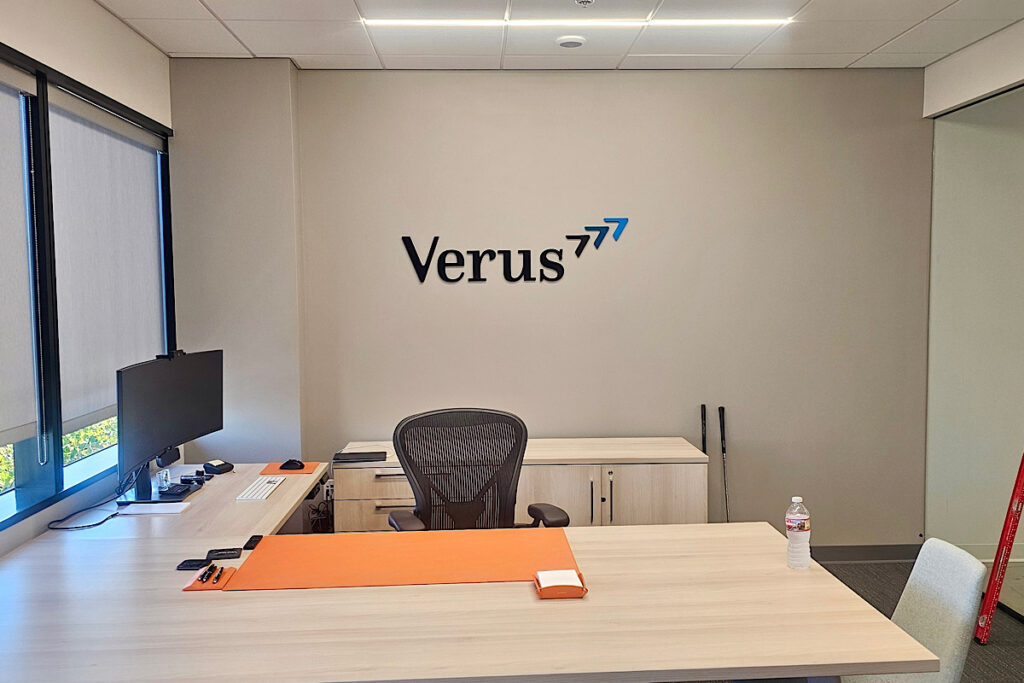 A wide view of a office with dimensional letters spelling "Verus" mounted above it. The letters are made of high-quality acrylic and complement the overall office design.