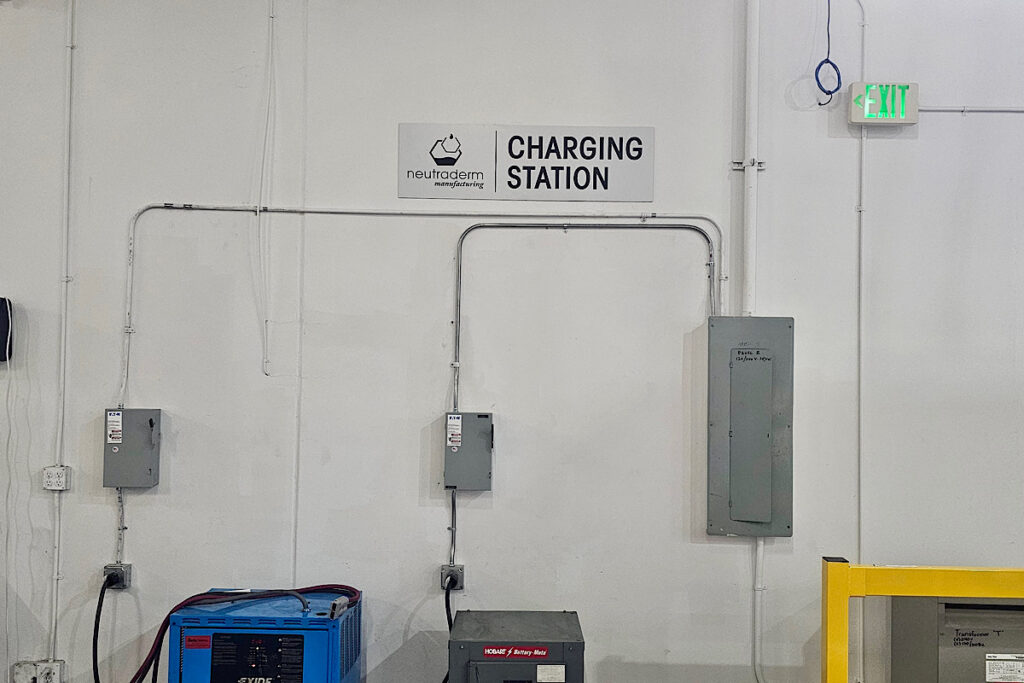 ADA-compliant charging station sign for Neutraderm, ensuring clear wayfinding.
