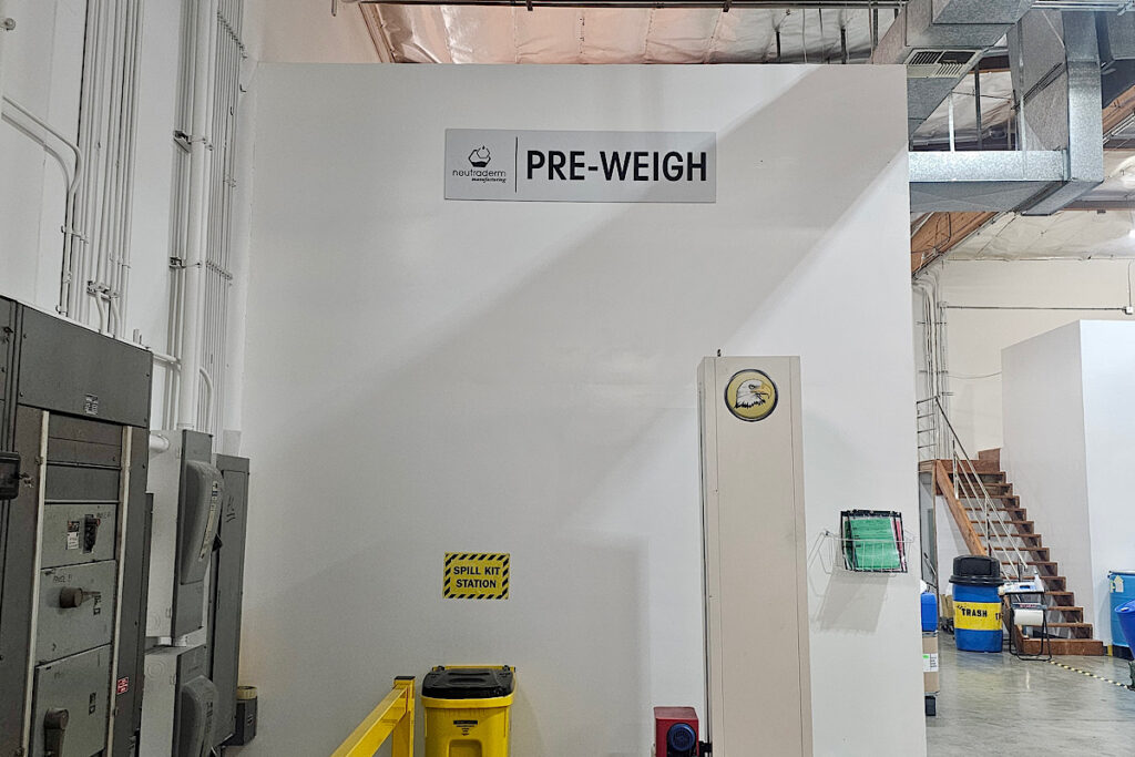 ADA-compliant pre weigh area sign at Neutraderm, featuring Dibond panel material.