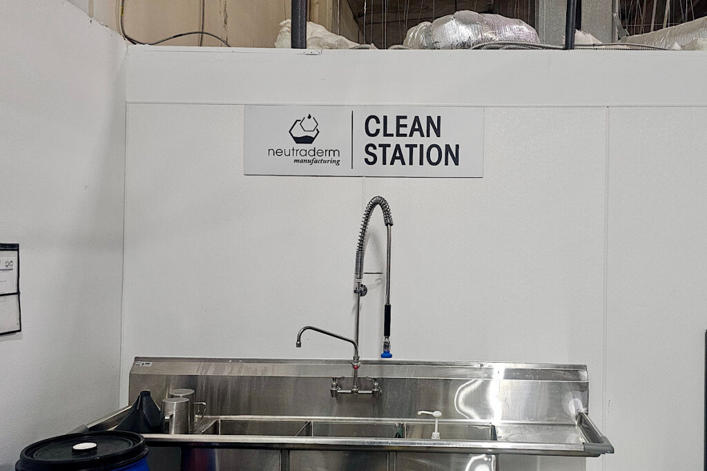 Neutraderm’s clean station sign is a custom ADA signage with professional design.
