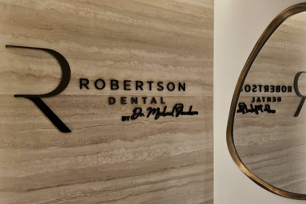 A side view of the Robertson Dental lobby sign, showcasing the intricate details and high-quality materials used in its construction.