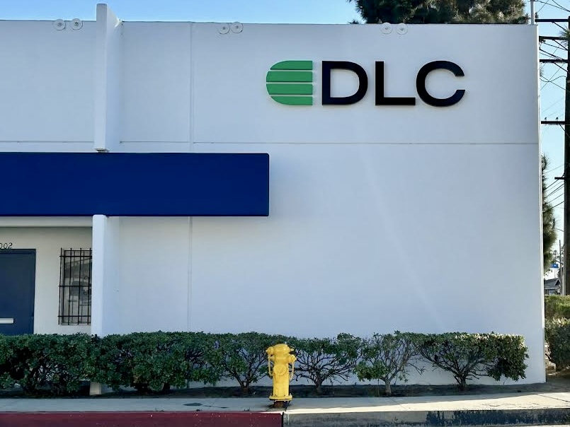 A wide shot of the  DLC Laboratories building with the prominent signage clearly visible from the street, demonstrating its effectiveness in wayfinding.
