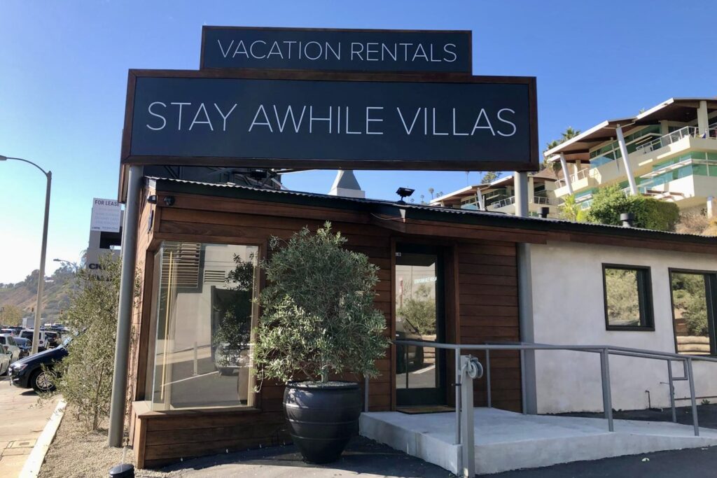 Custom hotel signage mounted on the exterior of Stay Awhile Malibu