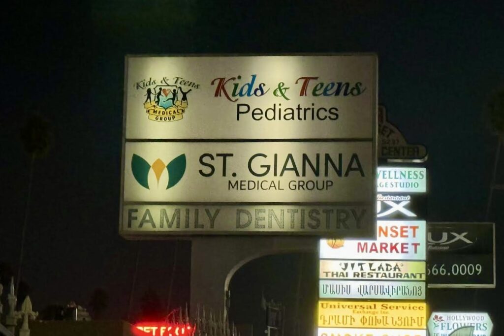 Night shot of an illuminated double-sided pole sign for St. Gianna Medical Group and Kids & Teens Pediatrics, ensuring visibility from all directions.
