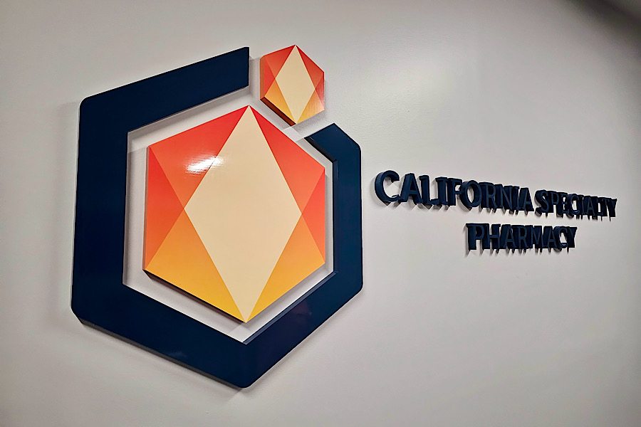 Photo of the orange and black acrylic lobby sign for California Specialty Pharmacy a perfect example of medical marketing signage.