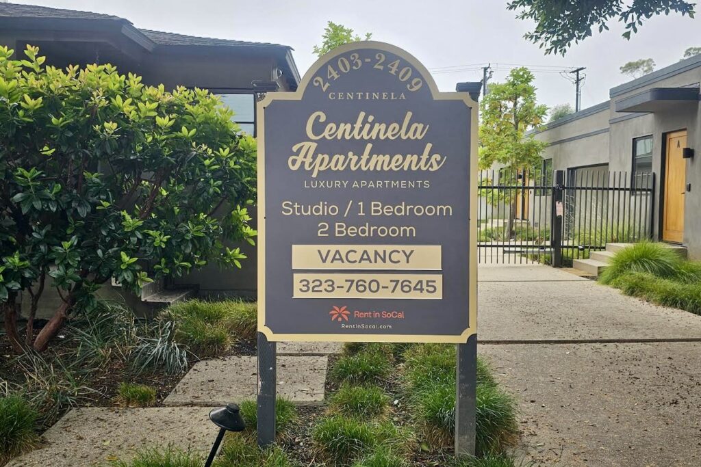 Image of the black lusterboard with gold trim and lettering. Apartment signage is integral to the easy of wayfinding for future tenants and service providers.